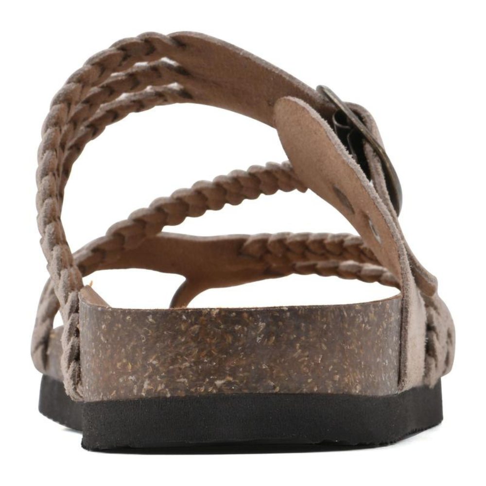 Woman wearing Kaelen braided cork sandals, walking on a paved pathway, illustrating comfort and mobility.